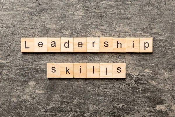 Leadership skills word written on wood block. Leadership skills text on cement table for your desing, concept.