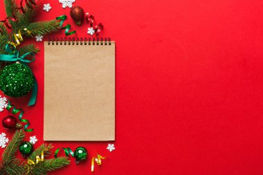 Christmas blank greeting card mock-up scene. Creative layout made of Christmas tree branches and paper card note. Flat lay. Nature New Year concept.