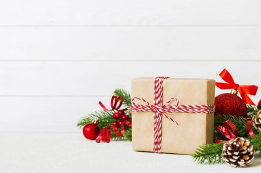 New Year Christmas mood, gift box, branches of a christmas tree, New Year decorations on a colored background.