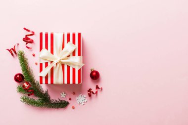 Top view Flat lay Christmas decorations and gift box on colored background with copy space. Christmas or Happy New Year composition.
