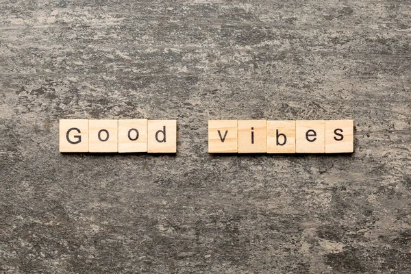 good vibes word written on wood block. good vibes text on table, concept.