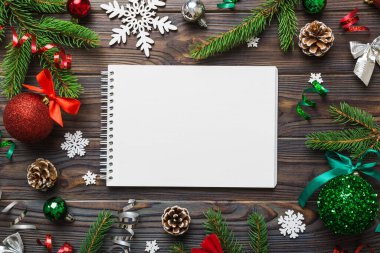 Christmas blank greeting card mock-up scene. Creative layout made of Christmas tree branches and paper card note. Flat lay. Nature New Year concept.