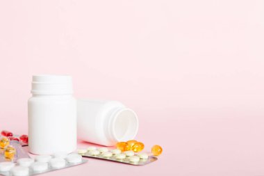 Medicine for treatment HIV infection. Pills and capsules and battle on the table. Different colorful tablets at colored background with copy space.