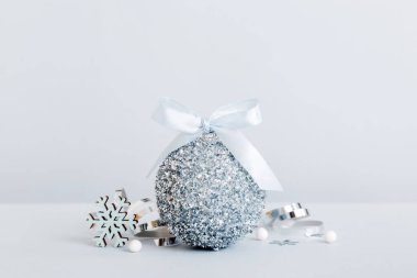 Christmas ball on colored background. decoration bauble with ribbon bow with copy space.