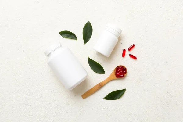 different drugs and health supplement pills with medicine bottle health care and medical top view. Vitamin tablets. Bottle with colored pills on table background. Multivitamins.