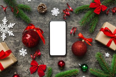 Digital phone mock up with rustic Christmas decorations for app presentation top view with empty space for you design. Christmas online shopping concept. Tablet with copy space on colored background.