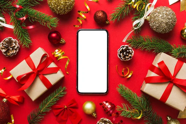 Digital phone mock up with rustic Christmas decorations for app presentation top view with empty space for you design. Christmas online shopping concept. Tablet with copy space on colored background.