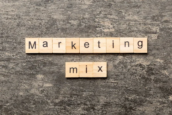 MARKETING MIX word written on wood block. MARKETING MIX text on cement table for your desing, concept.