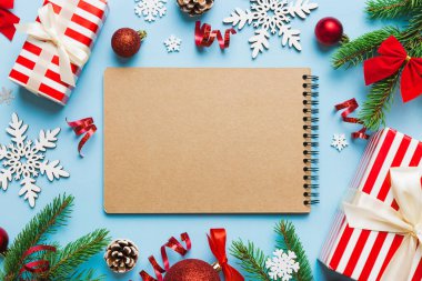 Christmas blank greeting card mock-up scene. Creative layout made of Christmas tree branches and paper card note. Flat lay. Nature New Year concept.