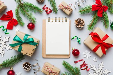 Christmas blank greeting card mock-up scene. Creative layout made of Christmas tree branches and paper card note. Flat lay. Nature New Year concept.