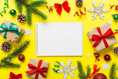 Christmas blank greeting card mock-up scene. Creative layout made of Christmas tree branches and paper card note. Flat lay. Nature New Year concept.