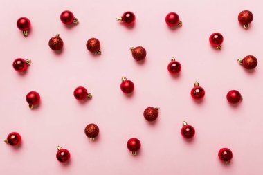Christmas composition. a pattern of christmas balls on colored background. Flat lay, top view New year decor.