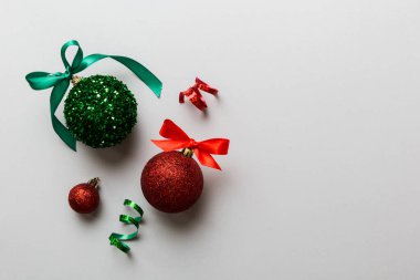 Christmas ball on colored background. decoration bauble with ribbon bow with copy space.