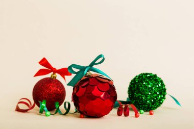 Christmas ball on colored background. decoration bauble with ribbon bow with copy space.
