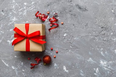 Top view Flat lay Christmas decorations and gift box on colored background with copy space. Christmas or Happy New Year composition.