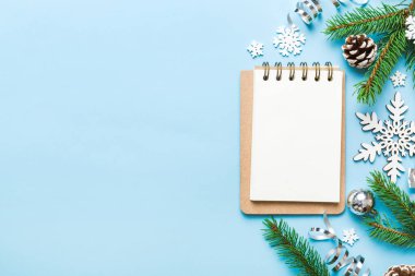 Christmas blank greeting card mock-up scene. Creative layout made of Christmas tree branches and paper card note. Flat lay. Nature New Year concept.