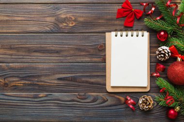 Christmas blank greeting card mock-up scene. Creative layout made of Christmas tree branches and paper card note. Flat lay. Nature New Year concept.