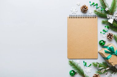 Christmas blank greeting card mock-up scene. Creative layout made of Christmas tree branches and paper card note. Flat lay. Nature New Year concept.