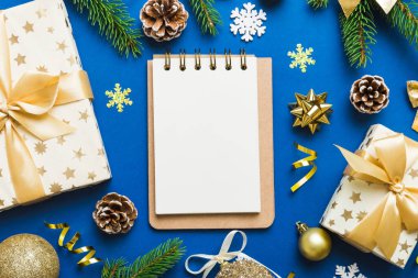 Christmas blank greeting card mock-up scene. Creative layout made of Christmas tree branches and paper card note. Flat lay. Nature New Year concept.