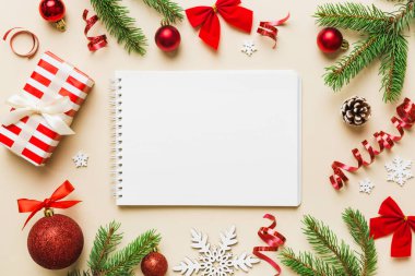 Christmas blank greeting card mock-up scene. Creative layout made of Christmas tree branches and paper card note. Flat lay. Nature New Year concept.