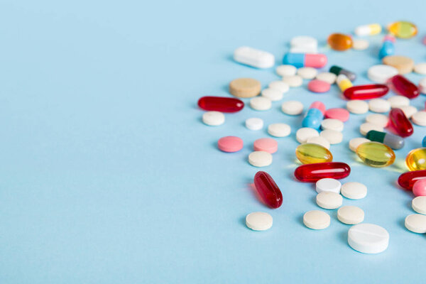 Many different colorful medication and pills perspective view. Set of many pills on colored background.