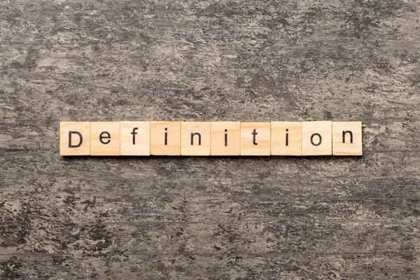 Definitionswort Auf Holzblock Geschrieben Definitionstext Auf Zementtisch Für Ihre Gestaltung — Stockfoto