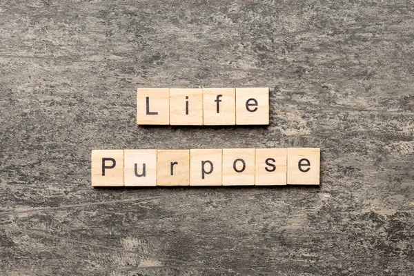 life purpose word written on wood block. life purpose text on cement table for your desing, concept.