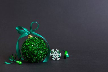 Christmas ball on colored background. decoration bauble with ribbon bow with copy space.