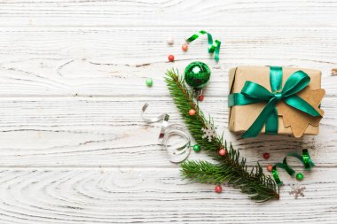 Top view Flat lay Christmas decorations and gift box on colored background with copy space. Christmas or Happy New Year composition.