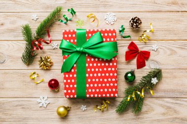 Top view Flat lay Christmas decorations and gift box on colored background with copy space. Christmas or Happy New Year composition.