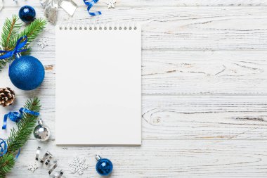 Christmas blank greeting card mock-up scene. Creative layout made of Christmas tree branches and paper card note. Flat lay. Nature New Year concept.