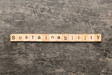 Tahta blokta yazılan sürdürülebilirlik kelimesi. Masada sürdürülebilirlik metni, konsept.