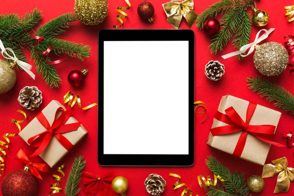 Digital tablet mock up with rustic Christmas decorations for app presentation top view with empty space for you design. Christmas online shopping concept. Tablet with copy space on colored background.