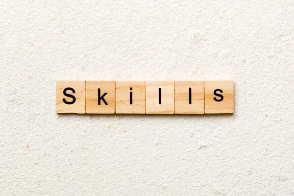 Skills word written on wood block. Skills text on cement table for your desing, concept.