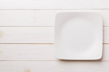 Ahşap zemin üzerinde boş kare plakanın üst görünümü. Tasarımın için boş boşluk.