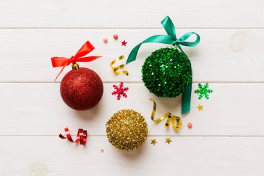 Christmas ball on colored background. decoration bauble with ribbon bow with copy space.
