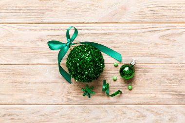 Christmas ball on colored background. decoration bauble with ribbon bow with copy space.