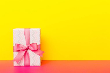 Tatil kağıdı hediyesi pembe kurdeleli pruva manzaralı fotokopi alanı. Tatil geçmişi düzdü. Doğum günü ya da Noel hediyesi. Kopya alanı olan Noel hediyesi kutusu konsepti.