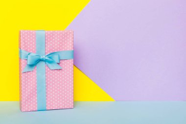 holiday handmade paper present tied blue ribbon bow top view with copy space. Flat lay holiday background. Birthday or christmas present. Christmas gift box concept with copy space.