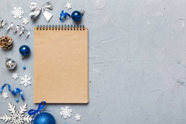 Christmas blank greeting card mock-up scene. Creative layout made of Christmas tree branches and paper card note. Flat lay. Nature New Year concept.