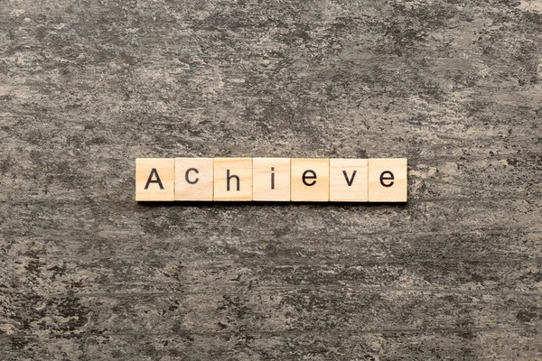 Achieve Word Written Wood Block Achieve Text Cement Table Your — Stock Photo, Image