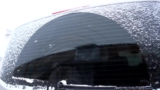 차량의 눈덮인 창문의 와이퍼가 작동하고 자동차 — 비디오