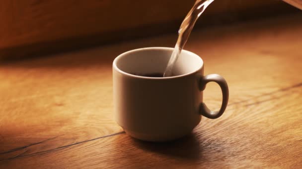 Reggel frissen főzött kávé fehér eszpresszó pohárban, fából készült asztalon. — Stock videók
