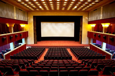 Hall of a cinema and lines of red armchairs clipart