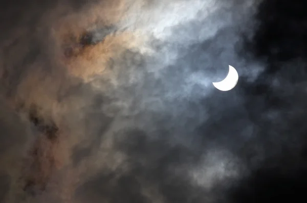 Solar eclipse through the clouds — Stock Photo, Image