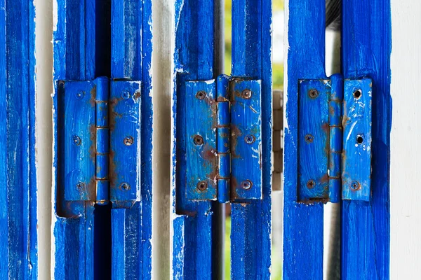 Wooden door with blue hinge — Stock Photo, Image