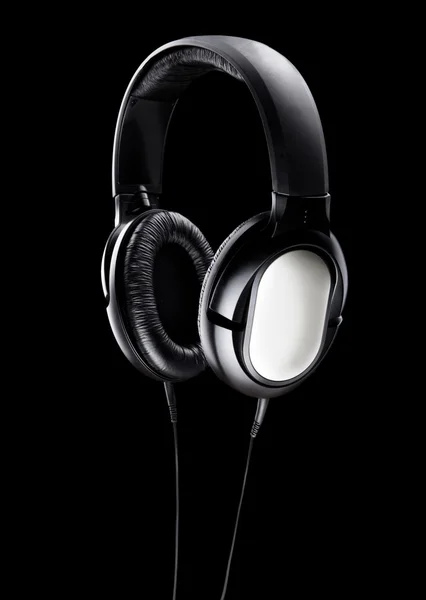 Black Pair of Headphones Isolated on a Black Background — Stock Photo, Image