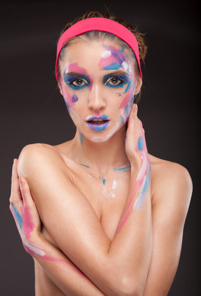 Beautiful fashion woman color face art portrait on blue background