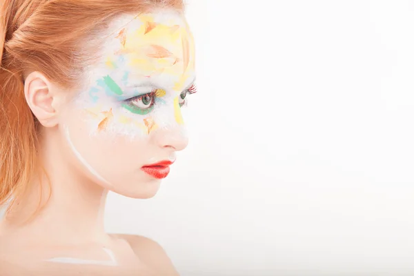 Schöne Mode Frau mit Farbe Gesicht Kunst. Stockbild