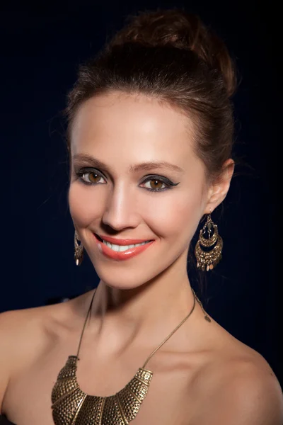 Girl in earrings and necklaces — Stock Photo, Image